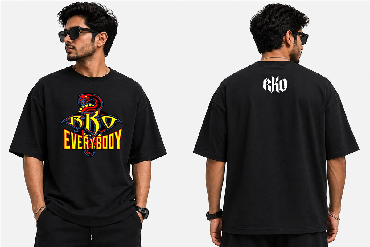 A man modeling a black graphic t-shirt from the front and back against a light gray background. The front features a colorful graphic with a skull and the text 'GK0 EVERYBODY' in yellow and red.