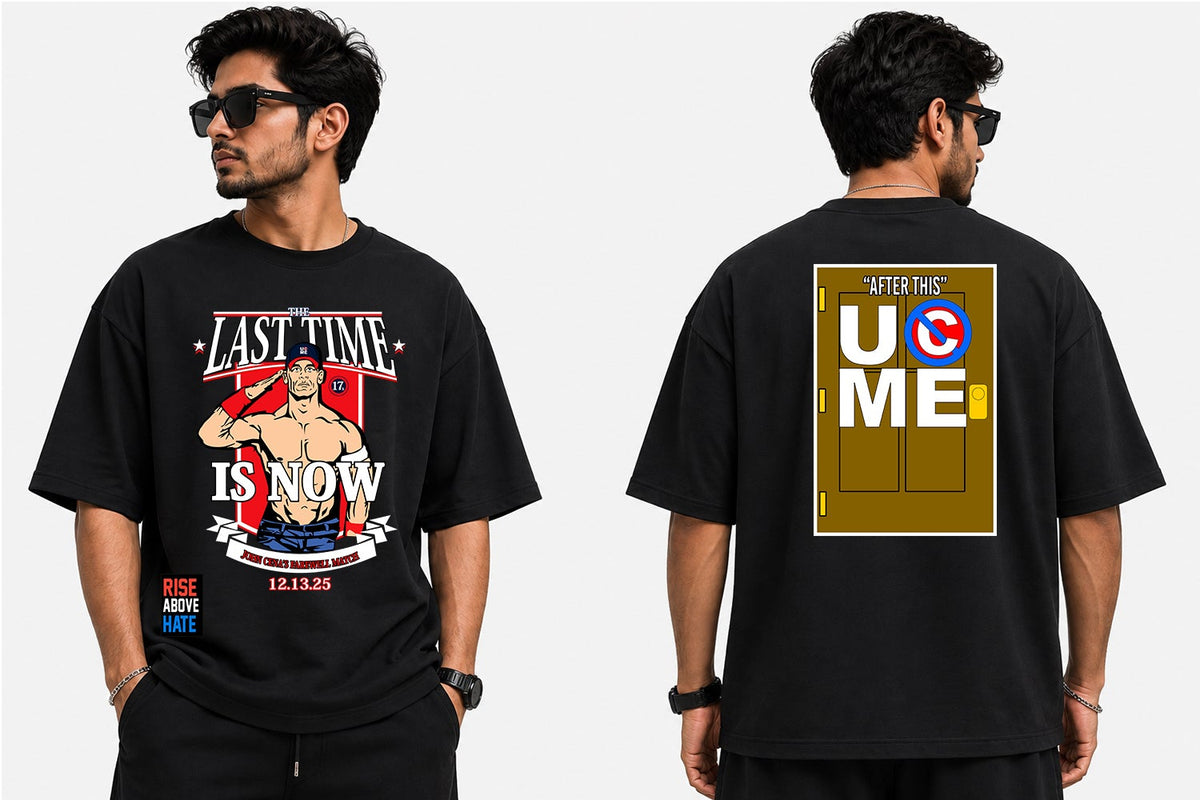 A man modeling a black graphic T-shirt shown from both front and back against a light gray studio background. The front features a large multicolor graphic with text and an illustrated figure, and the back has a large gold-toned graphic with bold lettering.