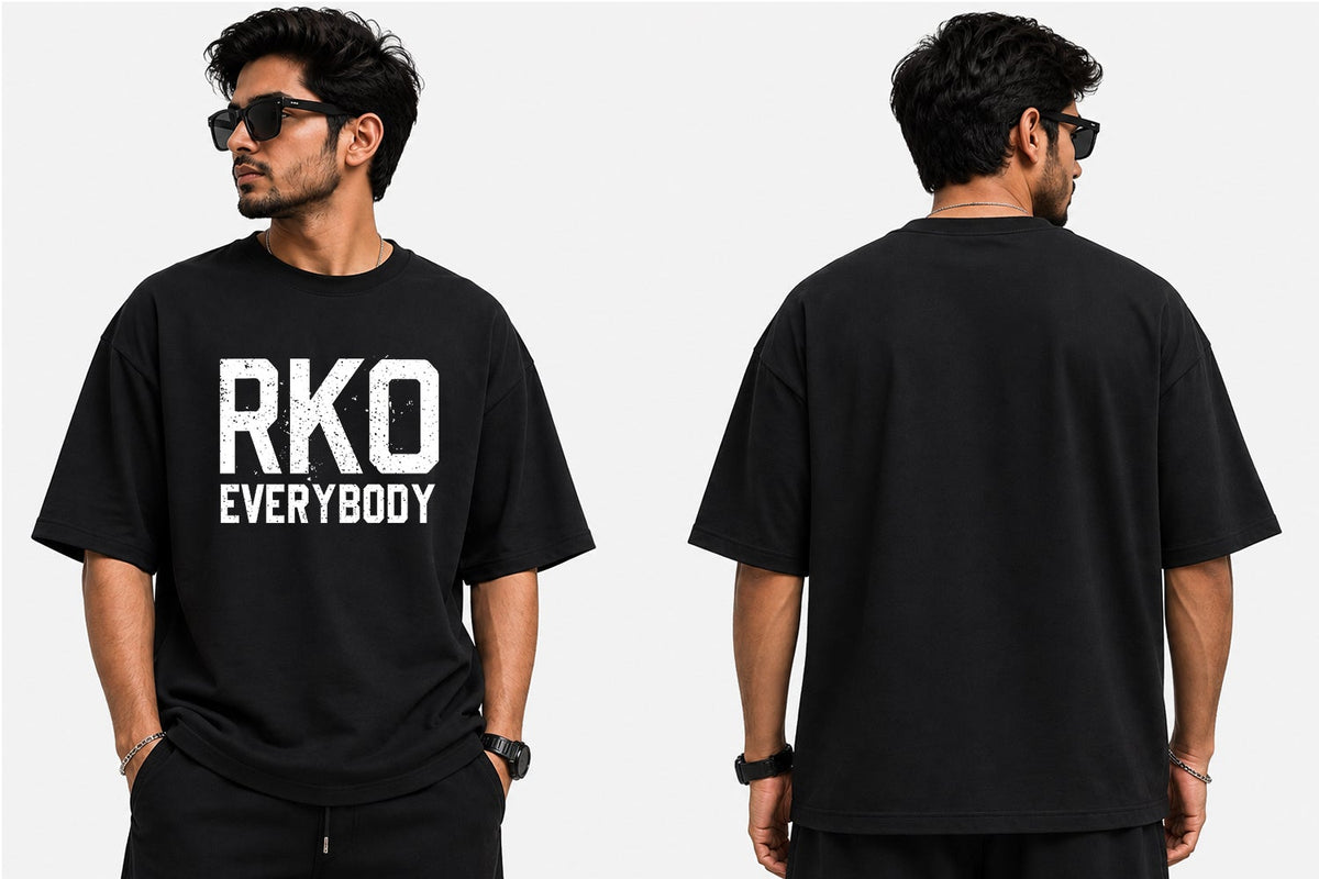 The design is built around the bold “RKO Everybody” message, combining strong typography with an energetic wrestling-inspired graphic style. The high-impact artwork creates a confident, edgy look that works naturally with jeans, joggers, shorts, and casual streetwear